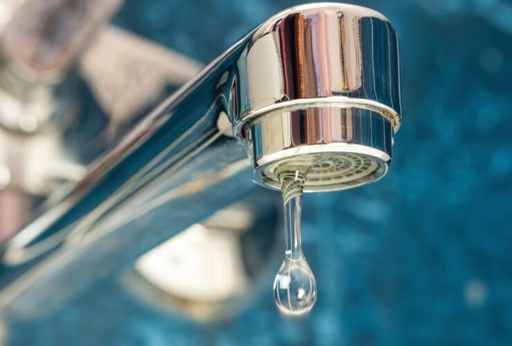 A drop of water drips from a leaky faucet.